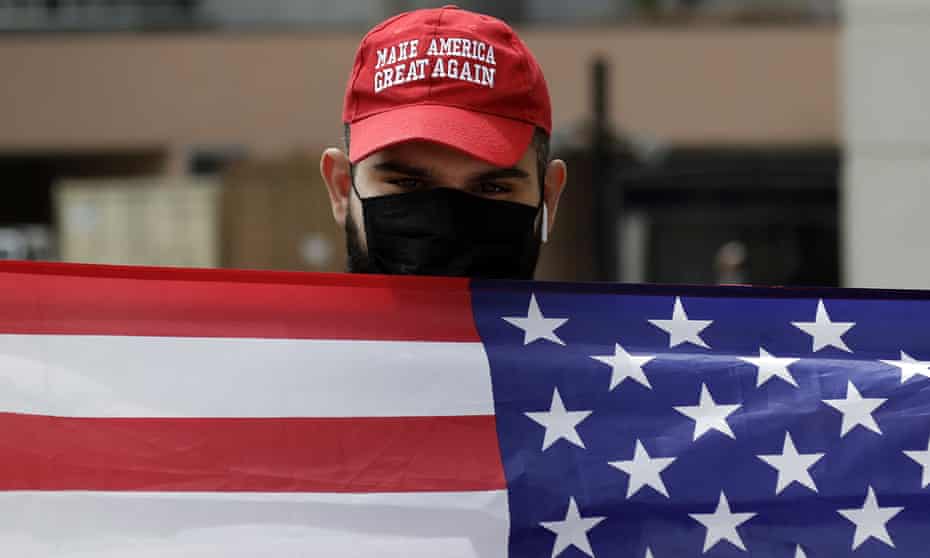 A supporter of President Trump waves a flag in Los Angeles. 