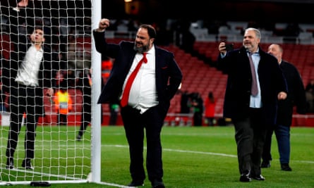 Olympiakos owner Evangelos Marinakis takes to the Emirates pitch after the Europa League win over Arsenal. He met several players after the game.