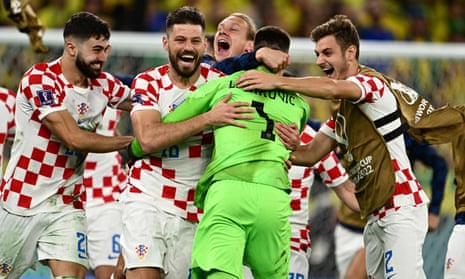 Croatia’s goalkeeper Dominik Livakovic and teammates celebrate after winning the penalty shootout against Brazil.