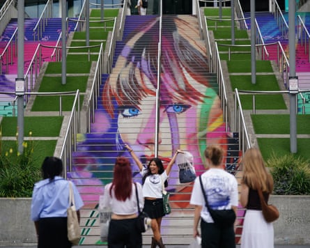 A Swiftie takes a photograph at the Swiftie Steps and murals at Wembley Park, London.