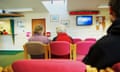 Patients sit in a GP surgery waiting room.