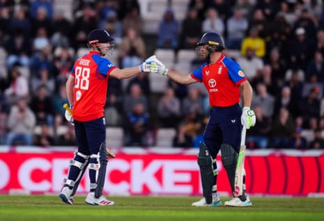 England's Harry Brook celebrates his half century with Jos Buttler (right).