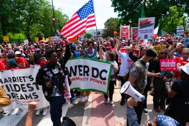 people hold signs and banners outside