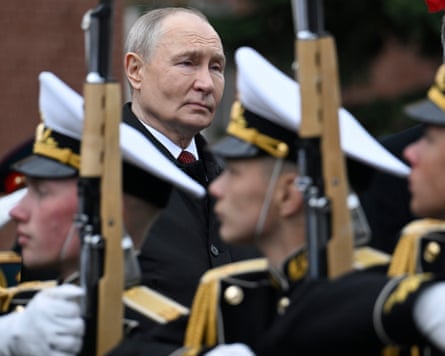 Russian President Vladimir Putin attends a ceremony to lay flowers at the Tomb of the Unknown Soldier by the Kremlin wall.