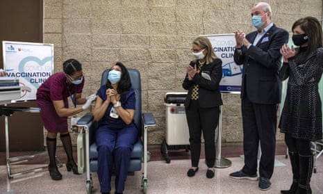 Nurse Maritza Beniquez became the first person in New Jersey to receive the Covid vaccine on 14 December as New Jersey governor Phil Murphy, second from right, watches.