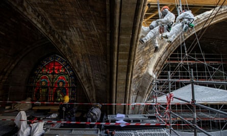Workers plaster stonework at the reconstruction site of Notre Dame, which was damaged in a fire two years ago.
