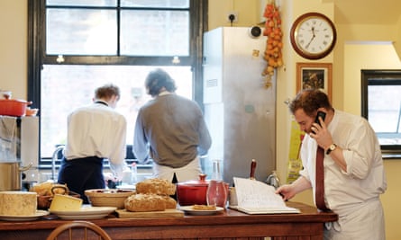 Chef Hugh Corcoran talking on the phone while looking in the bookings