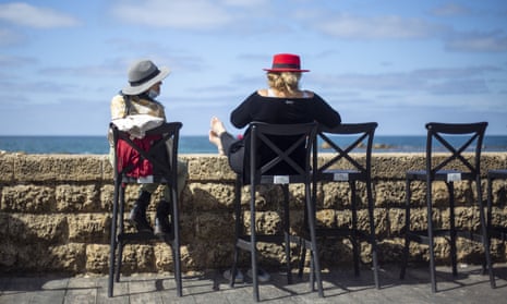 Women sit in a cafe overlooking the Mediterranean in Tel Aviv, Israel