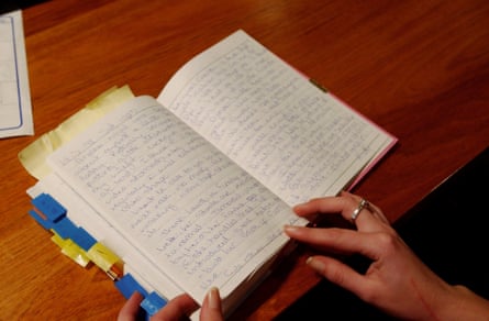 A diary with bookmarks open on a wooden table