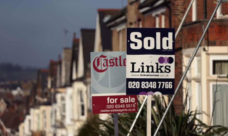 Estate agents’ signs outside houses in London