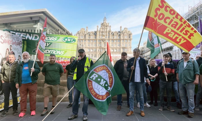 Members of the Rail, Maritime and Transport union (RMT) on the picket line outside Edinburgh Waverley train station.
