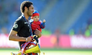 Mohamed Elneny celebrates with trophy and son after Basel won the Swiss Super League in 2014