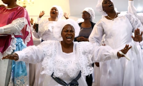 Worshippers sing as they offer thanksgivings during Sunday service at the New Jerusalem Parish