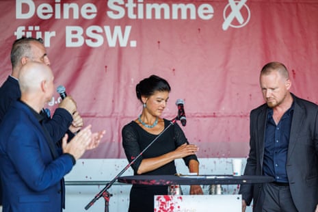 Sahra Wagenknecht (2nd R), who leads the leftist Sahra Wagenknecht Alliance (BSW), reacts as a coloured substance is thrown at her during a speech while campaigning ahead of Thuringia state elections on August 29, 2024 in Erfurt, Germany. eiqrkikhiqeeinv