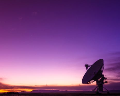 Radio telescope pointing at purple sky in Socorro, New Mexico.