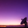 Radio telescope pointing at purple sky in Socorro, New Mexico.