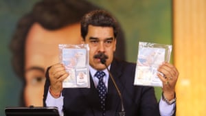 President Nicolas Maduro shows what Venezuelan authorities claim are identification documents of former US special forces and US citizens Airan Berry and Luke Denman