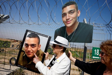 Varda Ben Baruch, holds a portrait of her grandson, hostage Edan Alexander.