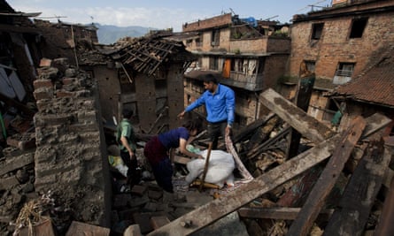 A Nepalese family collects belongings from their home in Bhaktapur on the outskirts of Kathmandu
