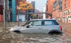 Flood waters surround a car parked at Hamburg’s Fish Market district on Sunday as a storm hit many parts of Germany.