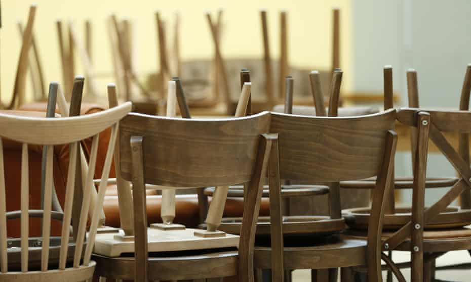 Empty cafe with chairs piled up