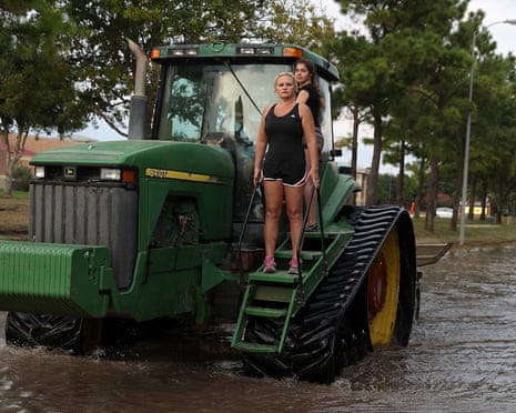 Houston Area Begins Slow Recovery From Catastrophic Harvey Storm Damage\<br\>KATY, TX - SEPTEMBER 04: Two girls ride through floodwaters an a tractor on September 4, 2017 in Katy, Texas. Over a week after Hurricane Harvey hit Southern Texas, residents are beginning the long process of recovering from the storm. (Photo by Justin Sullivan/Getty Images)