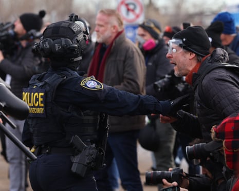 A potester confronts federal law enforcement outside the Bishop Henry Whipple Federal Building in Minneapolis, 9 January 2026.