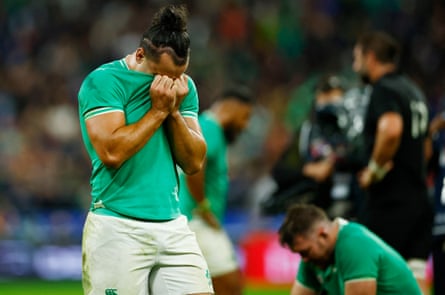 Ireland’s James Lowe covers his face with his shirt after the defeat by New Zealand