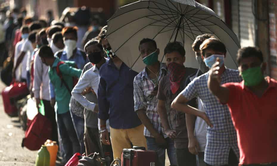 People queue for transport in Mumbai, India