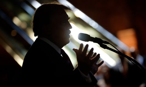silhouette of a man speaking into a microphone