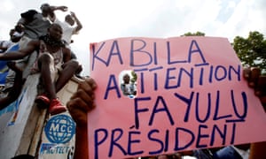 Supporters of Martin Fayulu hold a sign before a political rally in Kinshasa.