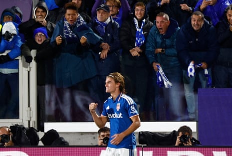 Nico Paz celebrates scoring a goal as fans cheer behind him