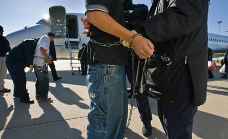 Undocumented immigrants, shackled at the wrists and ankles being searched at Kansas City International Airport