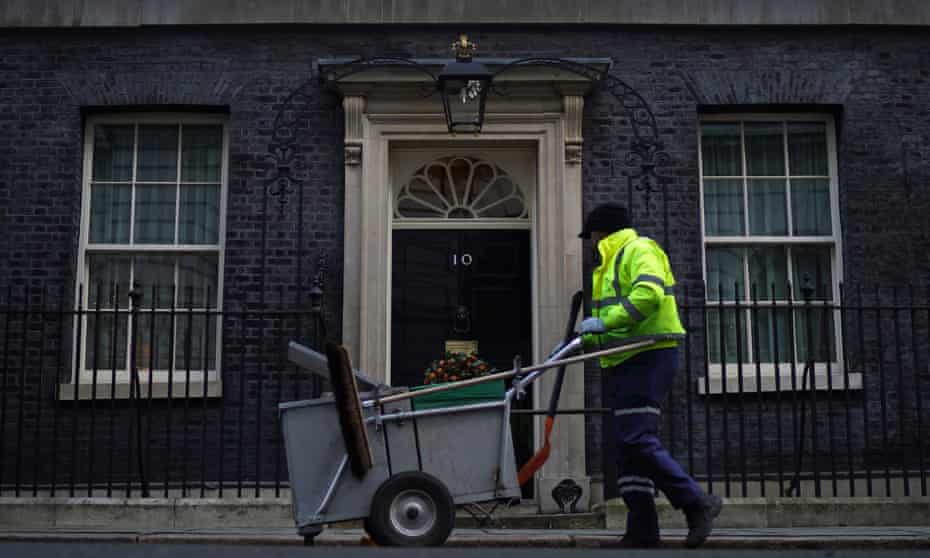 A cleaner working outside 10 Downing Street.