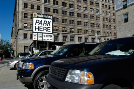 Vehicles are parked in a New York City parking lot.