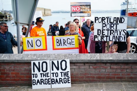 Protesters in Portland in Dorset opposed to the arrival of the barge.