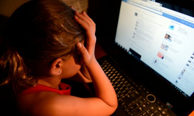 Upset young girl in front of a computer