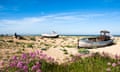 abandoned fishing boats on the beach.