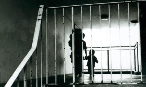 Silhouette of a mother and children in an apartment block hallway