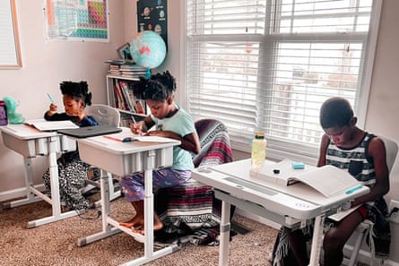 Drew Waller, seven, Zion Waller, 10, and Ahmad Waller, 11, left to right, study at home in Raleigh, NC.