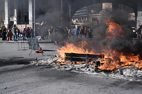 Protesters set a fire to blockade the port gates of San Benigno, in the port city Genova, Italy.