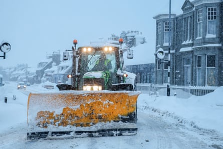A snowplough clears a road