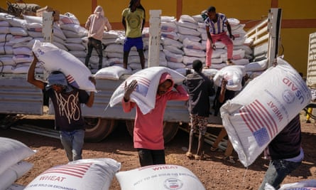 Volunteers at the Zanzalima Camp for Internally displaced people unload sacks of flour that were a part of an aid delivery from USAid in Bahir Dar, Ethiopia.