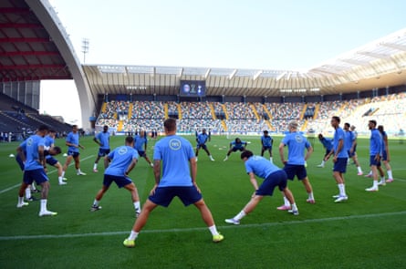 Tottenham players stand in a circle doing stretching exercises ahead of the Uefa Super Cup clash with Paris Saint-Germain