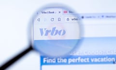 Vrbo's website underneath a magnifying glass