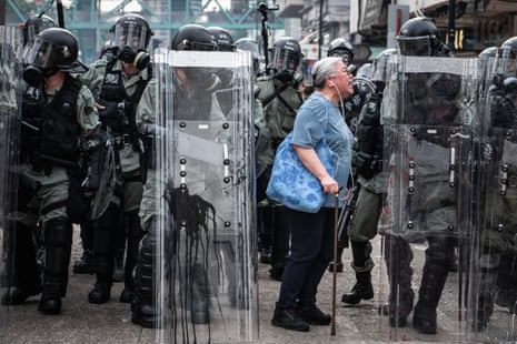A woman shouts at police officers in the district of Yuen Long on July 27, 2019.