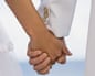 Linked hands of bride and groom