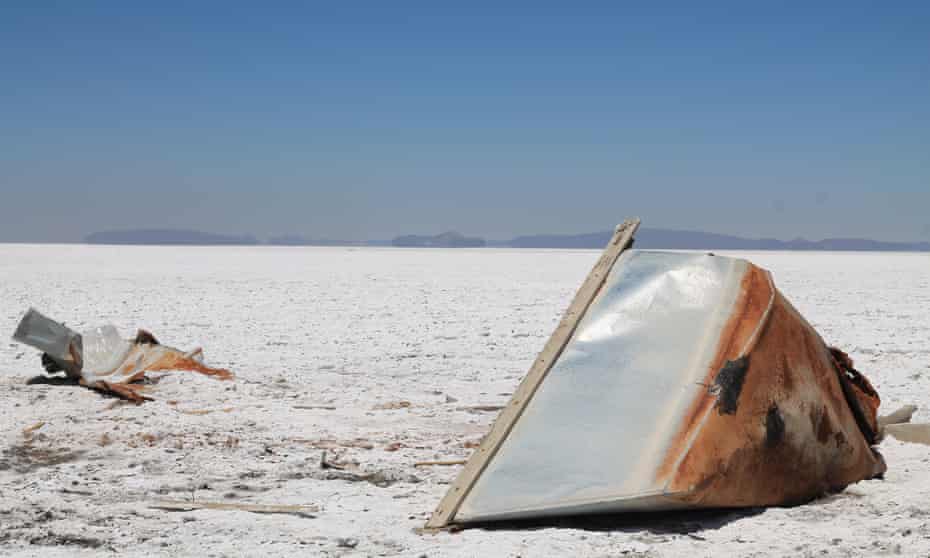 A boat lies on its side on the salt flat that used to be Lake Poopó.