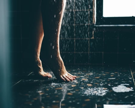 Woman taking a shower. Close up legs.