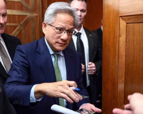Jensen Huang signing autographs as he enters a US Congress building.